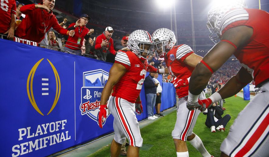 FILE - In this Dec. 28, 2019, file photo, Ohio State running back J.K. Dobbins, left, celebrates his touchdown with wide receiver Austin Mack during the first half of the team's Fiesta Bowl NCAA college football playoff semifinal against Clemson, in Glendale, Ariz. Clemson is preseason No. 1 in The Associated Press Top 25, Monday, Aug. 24, 2020, a poll featuring nine Big Ten and Pac-12 teams that gives a glimpse at what’s already been taken from an uncertain college football fall by the pandemic. Ohio State was a close No. 2. (AP Photo/Ross D. Franklin, File)
