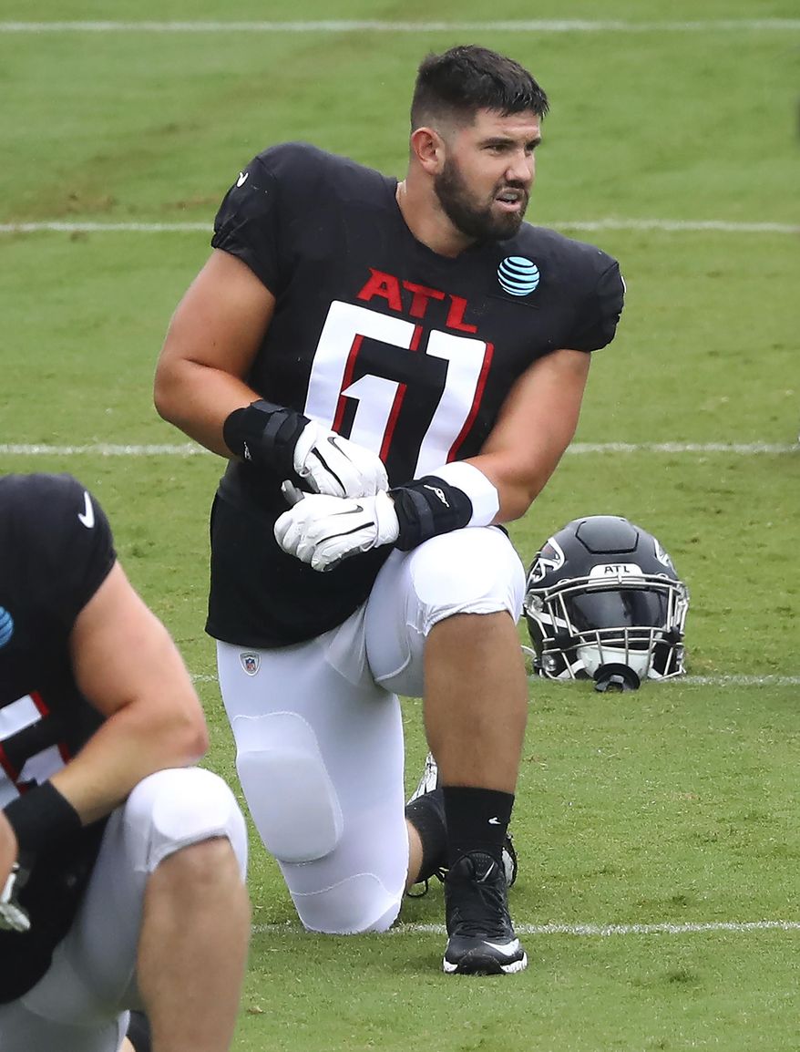 Atlanta Falcons rookie center Matt Hennessy loosens up during an NFL football training camp practice in Flowery Branch, Ga., Monday, Aug. 24, 2020. (Curtis Compton/Atlanta Journal-Constitution via AP, Pool)