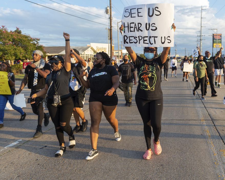 Protesters march down Amb Caffery and Johnston St. Sunday, Aug. 23, 2020, in Lafayette, La. (Scott Clause/The Daily Advertiser via AP)