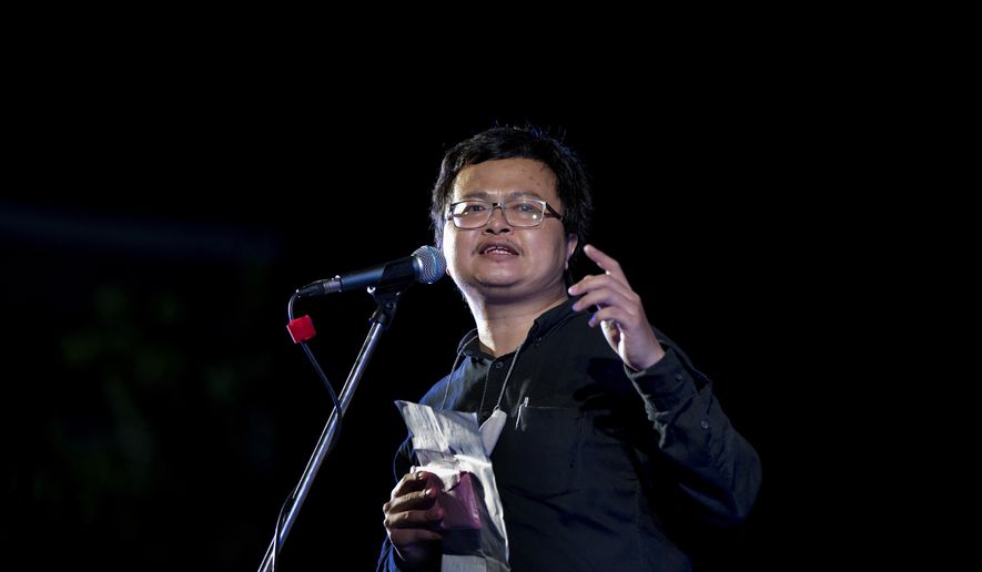 In this Sunday, Aug. 16, 2020, photo, pro-democracy activist and human rights lawyer Arnon Nampha delivers a speech during a protest rally at the Democracy Monument in Bangkok, Thailand. Thai police issued summons to five activists including Arnon who spoke at an anti-government rally in front of the army headquarters last July 20, for the violation of the emergency decree which prohibits public gatherings during the coronavirus outbreak. (AP Photo/Gemunu Amarasinghe)