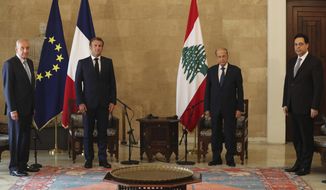 FILE - In this Aug. 6, 2020 file photo, French President Emmanuel Macron, second left, meets with Lebanese President Michel Aoun, second right, Lebanese Prime Minister Hassan Diab, right, and Lebanese Parliament Speaker Nabih Berri, left, at the presidential palace, in Baabda east of Beirut. Beirut&#39;s massive explosion fueled widespread anger at Lebanon&#39;s ruling elite, whose corruption and negligence many blame for the disaster. Yet, three weeks later, the change many hoped for is nowhere in sight. The same politicians are negotiating among themselves over a new government. (AP Photo/Thibault Camus, Pool, File)