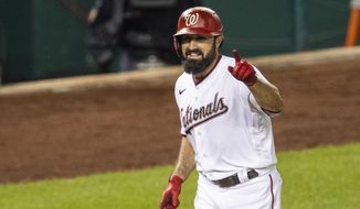 Washington Nationals&#39; Adam Eaton gestures to his dugout as he rounds the bases after hitting a home run during the sixth inning of a baseball game against the Philadelphia Phillies in Washington, Tuesday, Aug. 25, 2020. (AP Photo/Manuel Balce Ceneta)