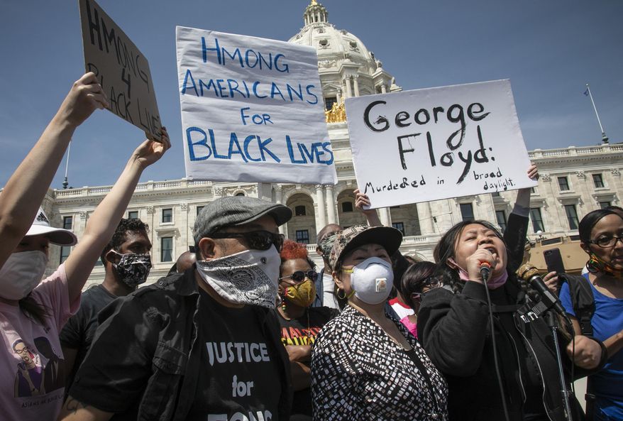 Ze Thao, second from right, addresses a Black Lives Matter rally for George Floyd with fellow Hmong activist Youa Vang Lee, center, at the Minnesota State Capitol, Sunday, May 31, 2020, in St. Paul, Minn. The climate of racial reckoning that has emerged in the United States since Floyd’s death has reinvigorated Native Americans, Asian Americans, Latinos and other people of color to fight back against the racism and discrimination they also have experienced for decades. (AP Photo/Bebeto Matthews)