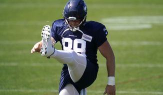 Seattle Seahawks&#39; Will Dissly stretches Tuesday, Aug. 18, 2020, during NFL football training camp in Renton, Wash. (AP Photo/Elaine Thompson)