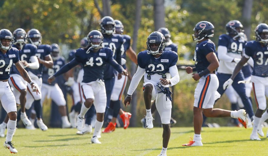 Chicago Bears defensive players warm-up and stretch NFL football training camp at Halas Hall in Lake Forest, Ill., on Wednesday, Aug. 26, 2020. (Jose M. Osorio/ Chicago Tribune via AP, Pool)