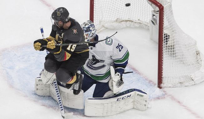 Vegas Golden Knights&#x27; Reilly Smith (19) jumps as the puck goes past Vancouver Canucks goalie Jacob Markstrom (25) during the third period of Game 2 of an NHL hockey second-round playoff series, Tuesday, Aug. 25, 2020, in Edmonton, Alberta. (Jason Franson/The Canadian Press via AP)