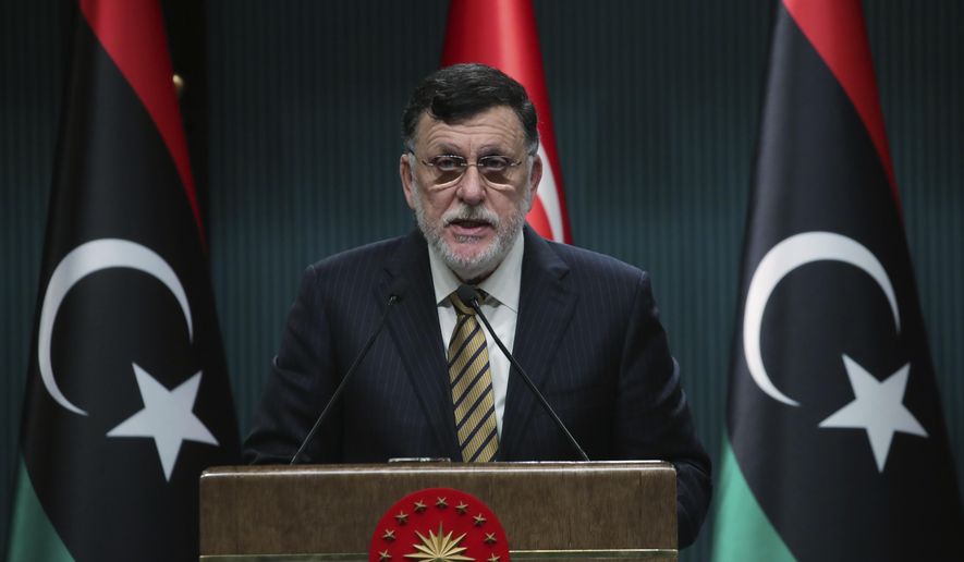 FILE - In this June 4, 2020 file photo, Fayez Sarraj, the head of Libya&#39;s internationally-recognized government, speaks at a joint news conference with Turkey&#39;s President Recep Tayyip Erdogan, in Ankara, Turkey.   Libya’s U.N.-supported government Friday, Aug. 21, 2020, announced a cease-fire across the oil-rich country and called for demilitarizing the strategic city of Sirte, which is controlled by rival forces.  (Turkish Presidency via AP, Pool)