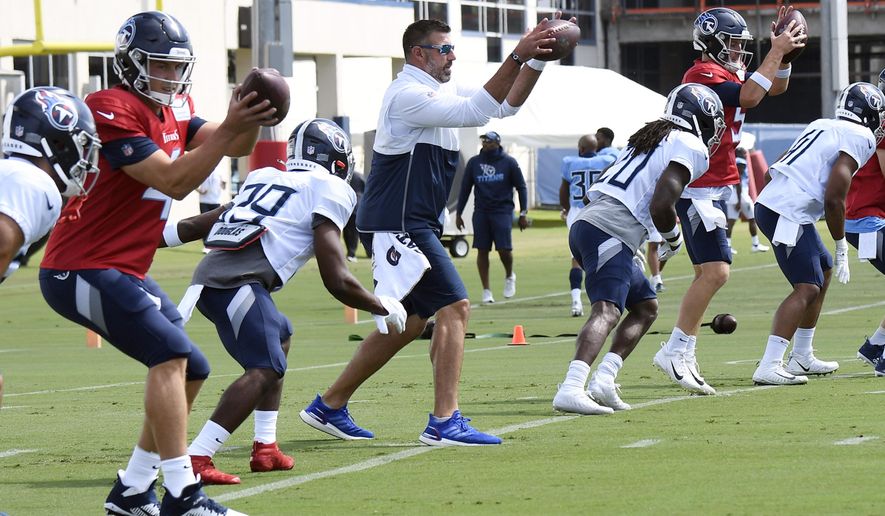 Tennessee Titans head coach Mike Vrabel, center, fills in at a quarterback spot for a drill during NFL football training camp Thursday, Aug. 20, 2020, in Nashville, Tenn.  (George Walker IV/The Tennessean via AP, Pool)