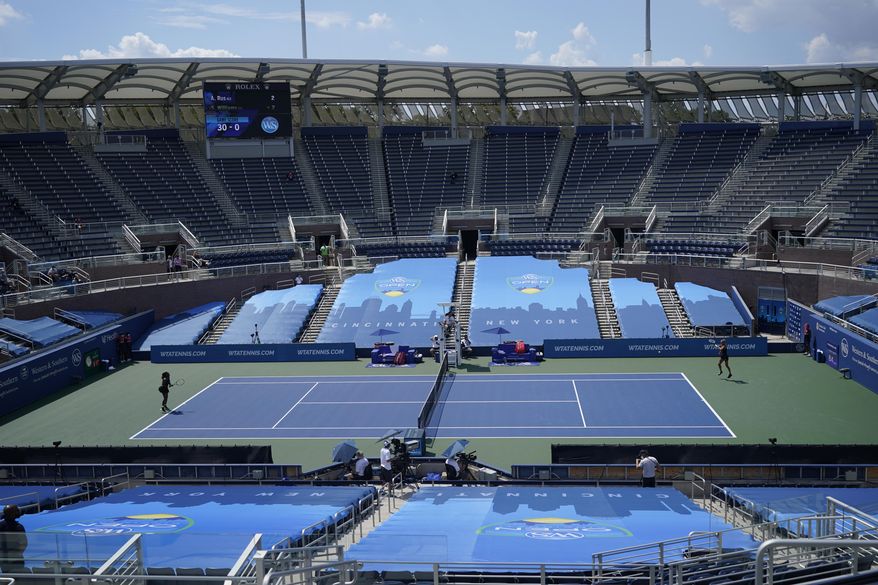 FILE - In this Monday, Aug. 24, 2020, file photo, Arantxa Rus, of the Netherlands, right, returns a shot from Serena Williams during a match at the Western & Southern Open tennis tournament in New York. In a year unlike any other, there will be a U.S. Open tournament unlike any other. (AP Photo/Frank Franklin II, File)