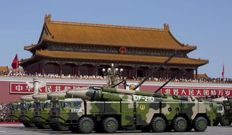 In this Sept. 3, 2015, file photo, Chinese military vehicles carrying DF-21D anti-ship ballistic missiles, potentially capable of sinking a U.S. Nimitz-class aircraft carrier in a single strike, pass by Tiananmen Gate during a military parade to commemorate the 70th anniversary of the end of World War II, in Beijing. China’s military test-fired two missiles into the South China Sea, including a “carrier killer” military analysts suggest might have been developed to attack U.S. forces, a newspaper reported Thursday, Aug. 27, 2020. (AP Photo/Andy Wong, Pool, File)  **FILE**