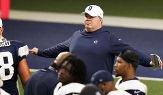 Dallas Cowboys head coach Mike McCarthy spreads his arms while taking a break with his team during an NFL football training camp in Frisco, Texas, Monday, Aug. 24, 2020. (AP Photo/LM Otero) **FILE**