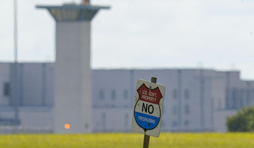 A No Trespassing sign stands in front the federal prison complex in Terre Haute, Ind., Wednesday, Aug. 26, 2020. A judge in Washington is halting for now the government’s planned Friday execution at the federal prison in Terre Haute, Indiana of Keith Dwayne Nelson who was convicted of kidnapping, raping and murdering at 10-year-old Kansas girl. (AP Photo/Michael Conroy, File)