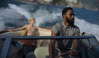 This image released by Warner Bros. Entertainment shows Elizabeth Debicki, left, and John David Washington in a scene from &amp;quot;Tenet.&amp;quot;  (Melinda Sue Gordon/Warner Bros. Entertainment via AP)
