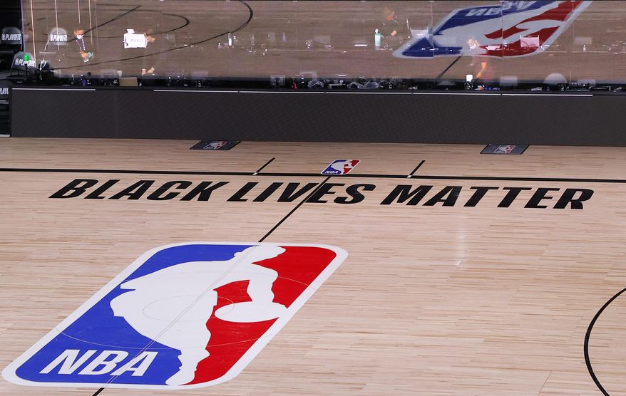 An empty court and bench are shown with no signage following the scheduled start time in Game 5 of an NBA basketball first-round playoff series, Wednesday, Aug. 26, 2020, in Lake Buena Vista, Fla. NBA players made their strongest statement yet against racial injustice Wednesday when the Milwaukee Bucks didn’t take the floor for their playoff game against the Orlando Magic. (Kevin C. Cox/Pool Photo via AP)