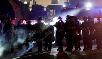 Authorities disperse protesters out of a park Tuesday, Aug. 25, 2020 in Kenosha, Wis. Anger over the Sunday shooting of Jacob Blake, a Black man, by police spilled into the streets for a third night. (AP Photo/Morry Gash)