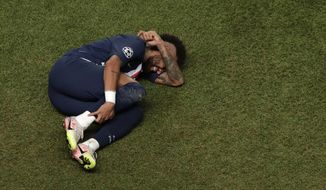 FILE - In this Sunday, Aug. 23, 2020 file photo, PSG&#39;s Neymar lies on the ground during the Champions League final soccer match between Paris Saint-Germain and Bayern Munich at the Luz stadium in Lisbon, Portugal. Paying for the world’s most expensive strikers cost Paris Saint-Germain 402 million euros, but Neymar and Kylian Mbappé failed to score a single goal during the Final Eight. (AP Photo/Manu Fernandez, Pool, File)