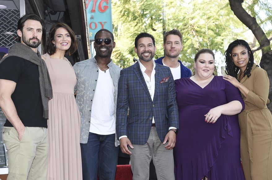 FILE - In this March 25, 2019, file photo, cast members from "This Is Us," from left, Milo Ventimiglia, Mandy Moore, Sterling K. Brown, Jon Huertas, Justin Hartley, Chrissy Metz and Susan Kelechi Watson pose for photographers at a ceremony honoring Moore with a star on the Hollywood Walk of Fame in Los Angeles. An optimistic NBC said Thursday, Aug. 27, 2020, it will bring “This Is Us” and other scripted series back in November despite the TV industry's coronavirus-caused production shutdown that's only beginning to ease. (Photo by Richard Shotwell/Invision/AP, File)