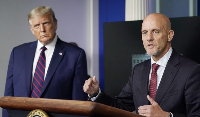 In this Aug. 23, 2020, file photo, President Donald Trump listens as Dr. Stephen Hahn, commissioner of the U.S. Food and Drug Administration, speaks during a media briefing in the James Brady Briefing Room of the White House in Washington. (AP Photo/Alex Brandon, File)