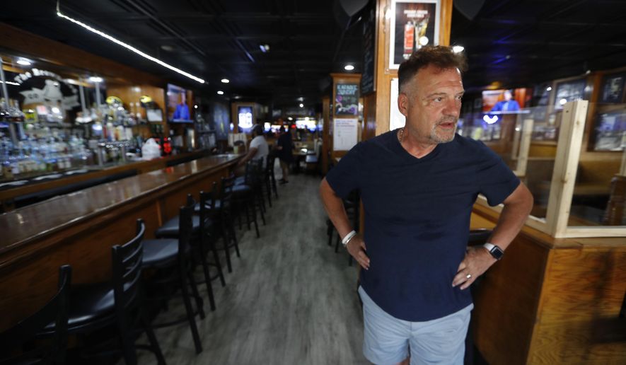 This photo shows Perry Porikos, owner of the The Brown Jug restaurant, in Ann Arbor, Mich. The Greek immigrant arrived here more than four decades ago as a 20-year-old soccer player for the Wolverines and part-time dishwasher at restaurant, which he now owns. (AP Photo/Paul Sancya)