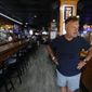 This photo shows Perry Porikos, owner of the The Brown Jug restaurant, in Ann Arbor, Mich. The Greek immigrant arrived here more than four decades ago as a 20-year-old soccer player for the Wolverines and part-time dishwasher at restaurant, which he now owns. (AP Photo/Paul Sancya)