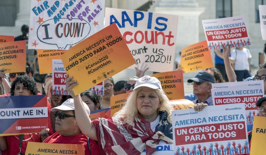 FILE - In this April 23, 2019 file photo, immigration activists rally outside the Supreme Court as the justices hear arguments over the Trump administration&#x27;s plan to ask about citizenship on the 2020 census, in Washington. The U.S. Census Bureau has spent much of the past year defending itself against allegations that its duties have been overtaken by politics. With a failed attempt by the Trump administration to add a citizenship question, the hiring of three political appointees with limited experience to top positions, a sped-up schedule and a directive from President Donald Trump to exclude undocumented residents from the process of redrawing congressional districts, the 2020 census has descended into a high-stakes partisan battle. (AP Photo/J. Scott Applewhite, File)