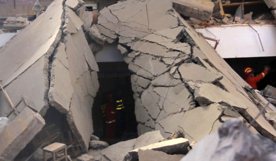 Rescuers search for victims in the aftermath of the collapse of a two-story restaurant in Xiangfen county in northern China's Shanxi province on Saturday, Aug. 29, 2020. More than a dozen were killed after the restaurant collapse during a gathering. (Chinatopix Via AP)