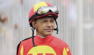 FILE- In this May 3, 2019, file photo, jockey Mike Smith looks on before a horse race at Churchill Downs in Louisville, Ky. Jockeys competing in the rescheduled 146th Kentucky Derby have to arrive five days ahead and then quarantine upon returning to their home tracks, just one of many changes forced by the coronavirus pandemic. (AP Photo/Gregory Payan, File)