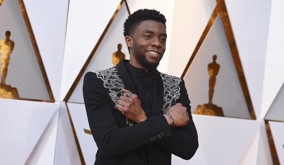 FILE - In this March 4, 2018 file photo, Chadwick Boseman arrives at the Oscars at the Dolby Theatre in Los Angeles.   Actor Chadwick Boseman, who played Black icons Jackie Robinson and James Brown before finding fame as the regal Black Panther in the Marvel cinematic universe, has died of cancer. His representative says Boseman died Friday, Aug. 28, 2020 in Los Angeles after a four-year battle with colon cancer. He was 43.  (Photo by Jordan Strauss/Invision/AP)