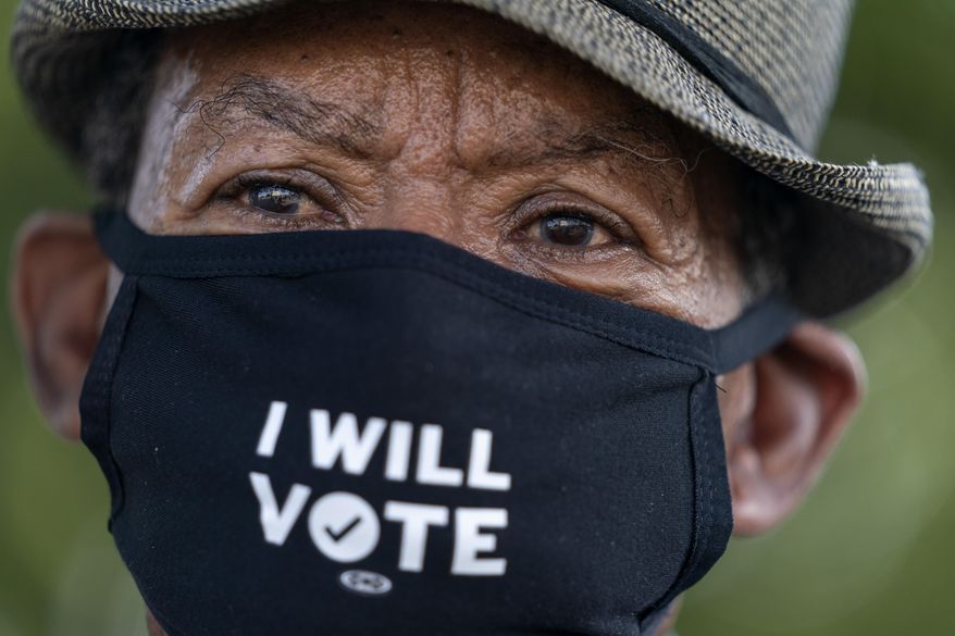 Walter Carter, 74, of Woodbridge, Va., who attended the original March on Washington, attends 2020's March on Washington, Friday Aug. 28, 2020, at the Lincoln Memorial in Washington, on the 57th anniversary of the Rev. Martin Luther King Jr.'s "I Have A Dream" speech. "This March is a celebration anniversary of the 1963 March on Washington," says Carter, "and the issues are very similar even though so much time has passed." (AP Photo/Jacquelyn Martin, Pool)