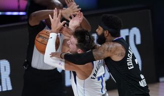Dallas Mavericks&#39; Luka Doncic (77) is fouled by Los Angeles Clippers&#39; Marcus Morris Sr. during the first half of an NBA first round playoff game Sunday, Aug. 30, 2020, in Lake Buena Vista, Fla. (AP Photo/Ashley Landis)