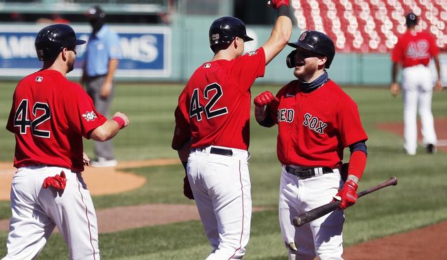 Boston Red Sox&#x27;s Bobby Dalbec, center, celebrates his two-run home run with Alex Verdugo, right, that also drove in Kevin Plawecki, left, during the third inning of a baseball game against the Washington Nationals, Sunday, Aug. 30, 2020, in Boston. (AP Photo/Michael Dwyer)