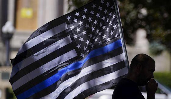 An unidentified man participates in a Blue Lives Matter rally Sunday, Aug. 30, 2020, in Kenosha, Wis. (AP Photo/Morry Gash)