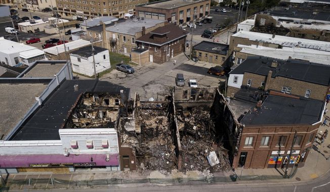 This Aug. 28, 2020 aerial photo shows damage to businesses in Kenosha, Wis. Police in Kenosha have arrested dozens of people since a white officer shot Jacob Blake in the back. Activists in the Wisconsin city say officers have been aggressive in responding to protests over the shooting Sunday of Blake, a Black man, even as they’ve tolerated armed militia groups. (Sean Krajacic/The Kenosha News via AP)