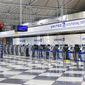 FILE - In this June 25, 2020, file photo, rows of United Airlines check-in counters at O&#39;Hare International Airport in Chicago are unoccupied amid the coronavirus pandemic. On Sunday, Aug. 30, 2020, United Airlines says it will be dropping an unpopular $200 fee for most people who change a ticket for travel within the United States. (AP Photo/Teresa Crawford, File)