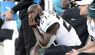 In this Nov. 24, 2019, file photo, Jacksonville Jaguars running back Leonard Fournette (27) sits on the bench in the first half of an NFL football game against the Tennessee Titans, in Nashville, Tenn. The Jacksonville Jaguars have waived running back Leonard Fournette, a stunning decision that gets the team closer to purging Tom Coughlin&#x27;s tenure. (AP Photo/Mark Zaleski, File)  **FILE**