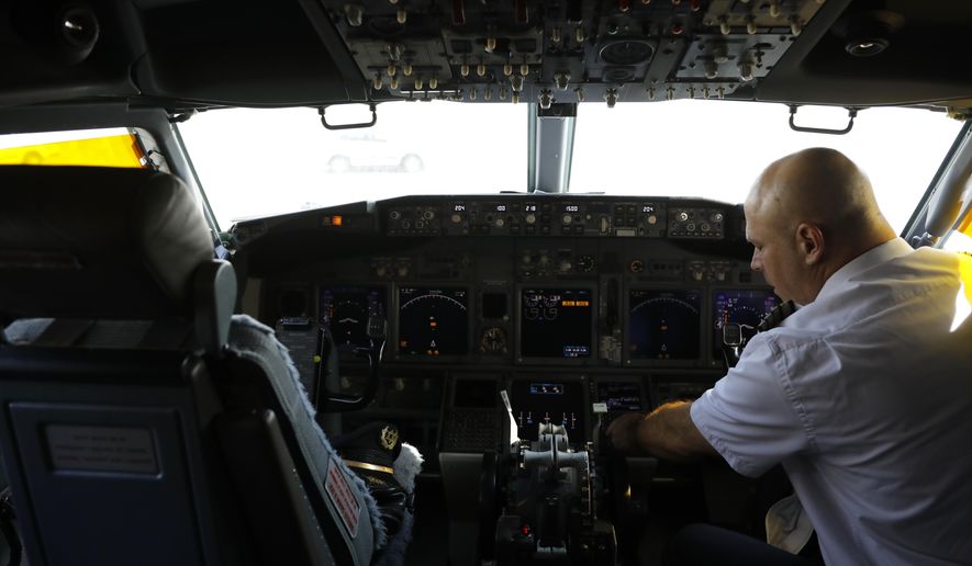 In this file photo, a member of the flight crew sits in the cockpit of the Israeli flag carrier El Al&#39;s airliner. U.S. telecoms have been forced to delay 5G rollout over aviation concerns even as European regulators have seen no concerns meriting a pause on the rollout.  (Nir Elias/Pool Photo via AP) **FILE**
