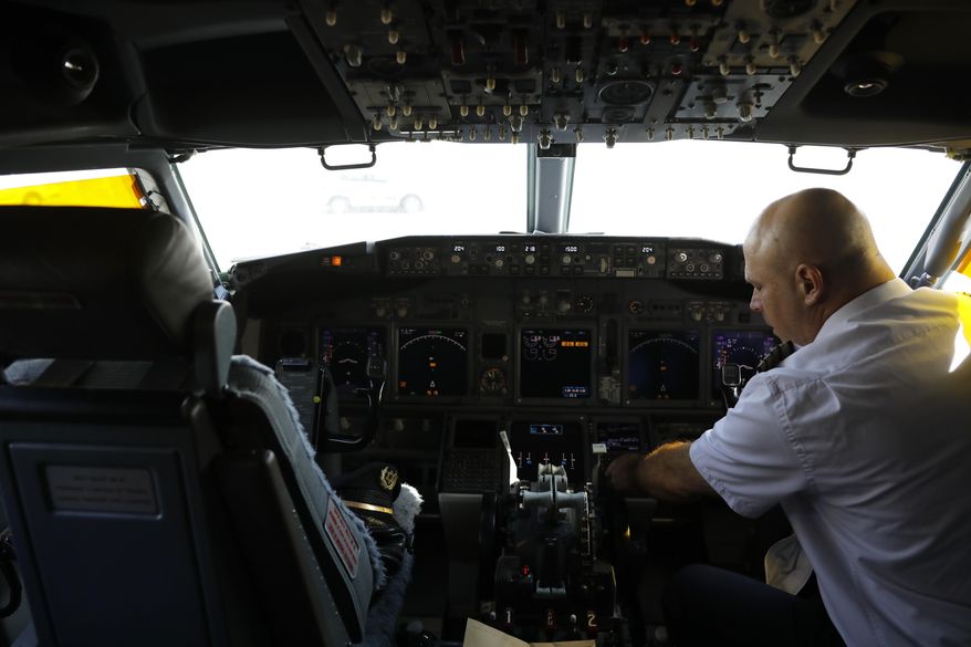In this file photo, a member of the flight crew sits in the cockpit of the Israeli flag carrier El Al&#x27;s airliner. U.S. telecoms have been forced to delay 5G rollout over aviation concerns even as European regulators have seen no concerns meriting a pause on the rollout.  (Nir Elias/Pool Photo via AP) **FILE**