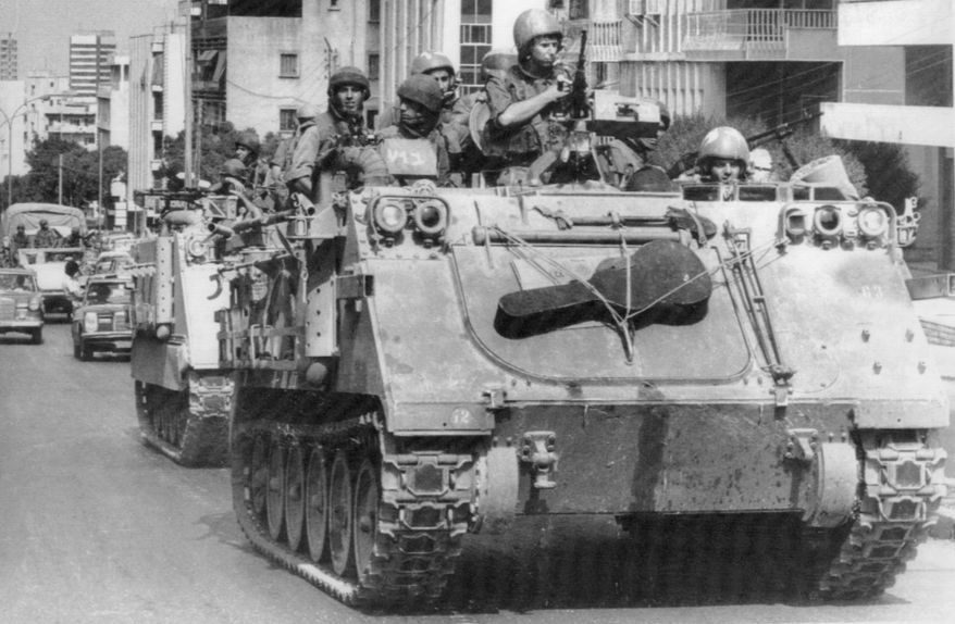 In this Sept. 28, 1982 file photo, Israeli tanks rumble through West Beirut streets, having just left the West Beirut port area. It was a century ago on Sept. 1, 1920, that a French general, Henri Gouraud, stood on the porch of the French residence in Beirut surrounded by local politicians and religious leaders and declared the State of Greater Lebanon - the precursor to the modern state of Lebanon. (AP Photo/Saris, File)