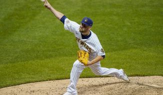 Milwaukee Brewers relief pitcher David Phelps throws during the seventh inning of a baseball game against the Pittsburgh Pirates Friday, Aug. 28, 2020, in Milwaukee. (AP Photo/Morry Gash)