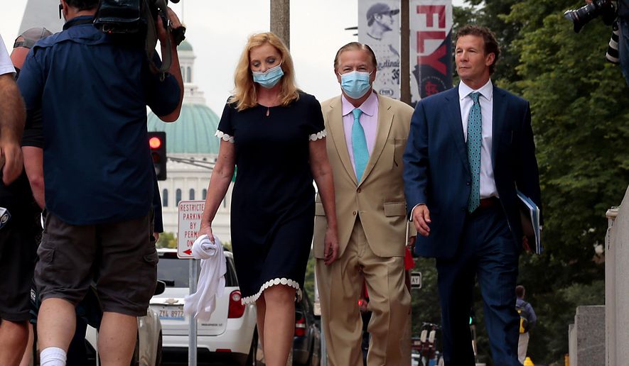 Mark and Patricia McCloskey and their attorney Joel Schwartz, right, leave court after a first appearance on felony weapons charges on Monday, Aug. 31, 2020, in St. Louis, Mo. The couple were charged in July with one felony count of unlawful use of a weapon — exhibiting, after they confronted protesters who were marching through their private street en route to Mayor Lyda Krewson's house in June. (Robert Cohen/St. Louis Post-Dispatch via AP)