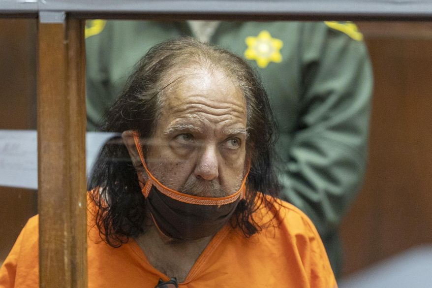 FILE - Adult film star Ron Jeremy appears for his arraignment on rape and sexual assault charges at Clara Shortridge Foltz Criminal Justice Center, on June 26, 2020, in Los Angeles. Jeremy has been charged with 20 new counts of rape or sexual assault involving 12 women and a teenage girl. Authorities say the new counts were filed Monday, Aug. 31. (David McNew/Pool Photo via AP, File)
