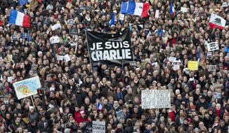 In this Jan. 11, 2015, file photo, thousands of people gather at Republique Square in Paris. The January 2015 attacks against Charlie Hebdo and, two days later, a kosher supermarket, touched off a wave of killings claimed by the Islamic State group across Europe. Seventeen people died along with the three attackers. Thirteen men and a woman accused of providing the attackers with weapons and logistics go on trial on terrorism charges Wednesday, Sept. 2. (AP Photo/Peter Dejong, File)