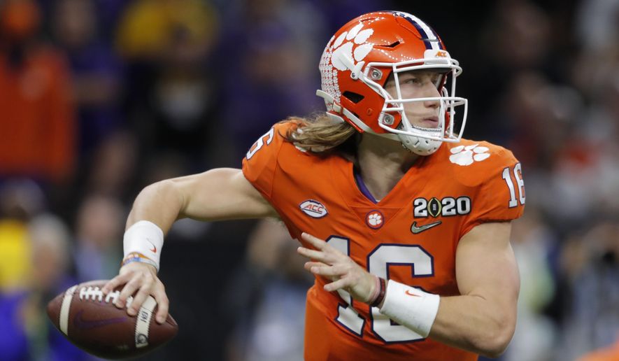In this Jan. 13, 2020, file photo, Clemson quarterback Trevor Lawrence looks to pass against LSU during the second half of an NCAA College Football Playoff national championship game in New Orleans. The top-ranked Tigers are 29-1 over the past two seasons and have won five straight ACC championships. (AP Photo/Gerald Herbert, File) **FILE**
