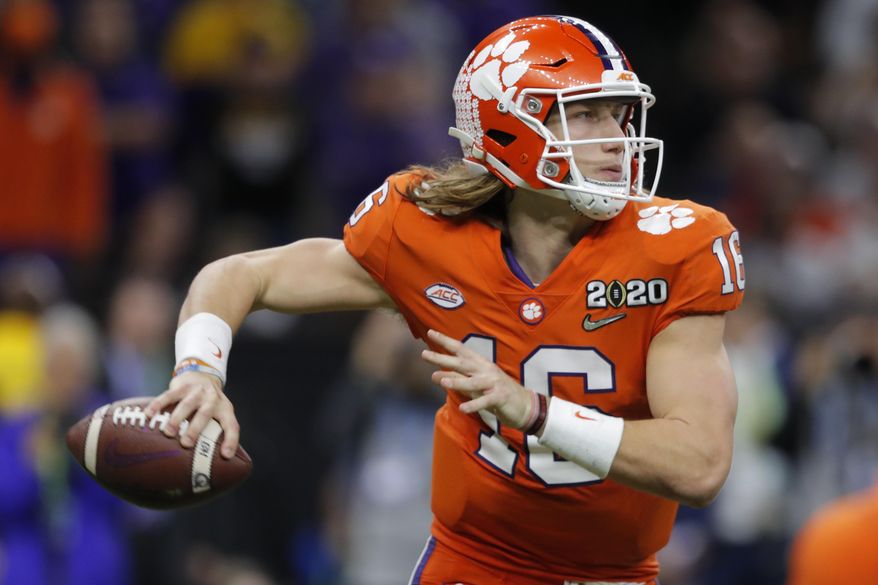 In this Jan. 13, 2020, file photo, Clemson quarterback Trevor Lawrence looks to pass against LSU during the second half of an NCAA College Football Playoff national championship game in New Orleans. The top-ranked Tigers are 29-1 over the past two seasons and have won five straight ACC championships. (AP Photo/Gerald Herbert, File) **FILE**