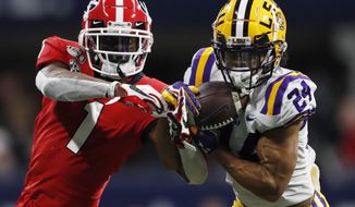 FILE - In this Dec. 7, 2019, file photo, LSU cornerback Derek Stingley Jr. (24) intercepts the ball from Georgia wide receiver George Pickens (1) during the second half of the Southeastern Conference championship NCAA college football game in Atlanta. Stingley Jr. was selected to The Associated Press preseason All-America first-team, Tuesday, Aug. 25, 2020. (AP Photo/John Bazemore, File)