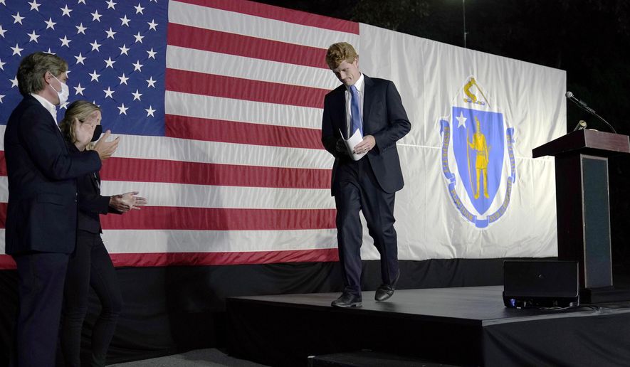 U.S. Rep. Joe Kennedy III leaves the stage after speaking outside his campaign headquarters in Watertown, Mass., after conceding defeat to incumbent U.S. Sen. Edward Markey, Tuesday, Sept. 1, 2020, in the Massachusetts Democratic Senate primary. Applauding at left are his twin brother Matthew and wife Lauren. (AP Photo/Charles Krupa)