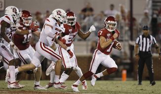 FILE - In this Saturday, Sept. 7, 2019 file photo, Oklahoma quarterback Spencer Rattler (7) carries in the fourth quarter of an NCAA college football game against South Dakota, in Norman, Okla. Rattler is competing with Tanner Mordecai for the starting spot. (AP Photo/Sue Ogrocki, File)
