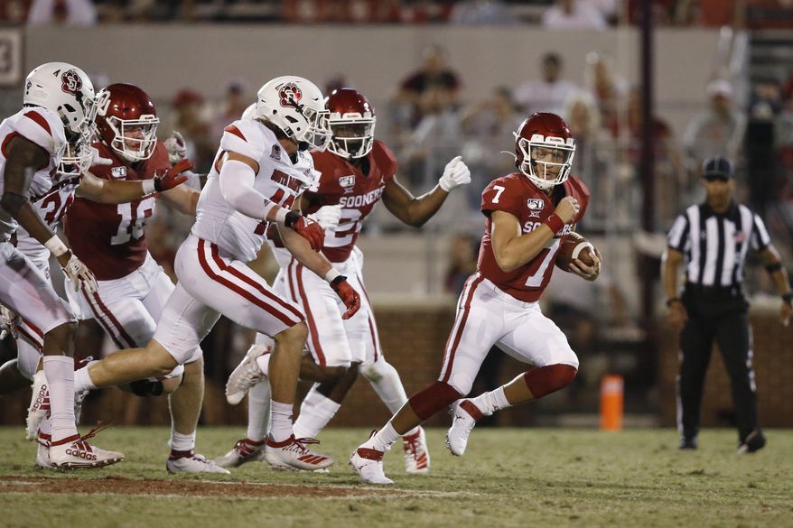 FILE - In this Saturday, Sept. 7, 2019 file photo, Oklahoma quarterback Spencer Rattler (7) carries in the fourth quarter of an NCAA college football game against South Dakota, in Norman, Okla. Rattler is competing with Tanner Mordecai for the starting spot. (AP Photo/Sue Ogrocki, File)