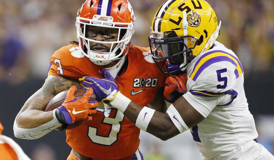 FILE - In this Jan. 13, 2020, file photo, Clemson wide receiver Amari Rodgers, left, is tackled by LSU cornerback Kary Vincent Jr. during the first half of a NCAA College Football Playoff national championship game in New Orleans. All-America wide receiver Ja’Marr Chase, Vincent and defensive end Neil Farrell Jr. have announced they won’t be playing this season. (AP Photo/Gerald Herbert, File)