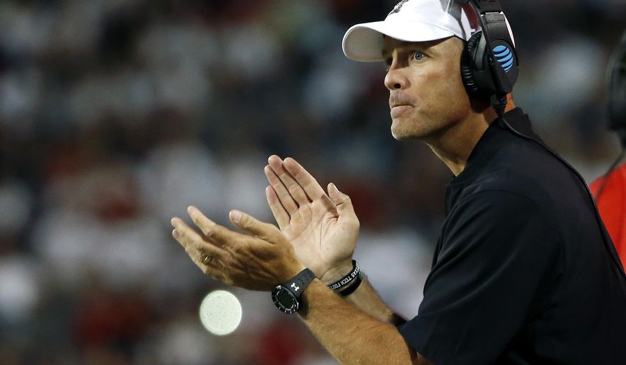FILE - In this Sept. 14, 2019, file photo, Texas Tech coach Matt Wells applauds his team during the first half of an NCAA college football game against Arizona in Tucson, Ariz. Wells said at the start of this fall's camp that there was no question Alex Bowman was in line to take the first snap, and it was the sophomore quarterback's job “to solidify that role and extend his lead. It's up to him to play well.” (AP Photo/Ralph Freso, File)